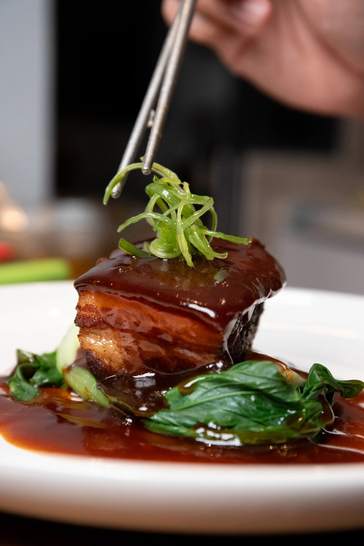 Glazed Cantonese dish served with greens